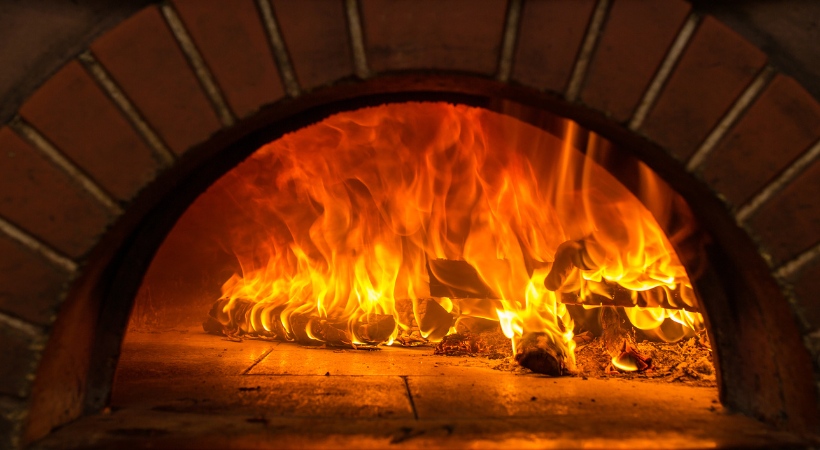 Professionally seasoned firewood that is burning in a wood-burning oven in the Greater Baltimore Area.