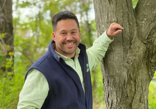 A-AAA Tree Service co-owner Andrew Senker leaning against a tree in Baltimore, MD.